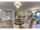 Elegant dining area with glass-top table and modern chandelier at 4450 Gulf Blvd # 104, St Pete Beach, FL 33706