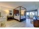 Elegant main bedroom with a four poster bed and ocean views at 4450 Gulf Blvd # 104, St Pete Beach, FL 33706