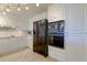 Modern kitchen with black appliances and white cabinets at 4450 Gulf Blvd # 104, St Pete Beach, FL 33706