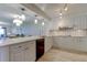 Modern kitchen with white cabinets, quartz countertops, and stainless steel appliances at 4450 Gulf Blvd # 104, St Pete Beach, FL 33706