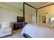 Spacious bedroom with a comfortable bed, large TV, and plenty of natural light at 4450 Gulf Blvd # 104, St Pete Beach, FL 33706