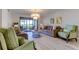 Spacious living room with comfortable seating and large windows at 4450 Gulf Blvd # 104, St Pete Beach, FL 33706