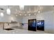 Modern kitchen with island, white cabinets, and black appliances at 4450 Gulf Blvd # 104, St Pete Beach, FL 33706