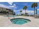 Community pool and spa with ocean views and patio furniture at 4450 Gulf Blvd # 104, St Pete Beach, FL 33706