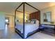 Bright bedroom with four-poster bed and ensuite access at 4450 Gulf Blvd # 104, St Pete Beach, FL 33706