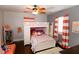 Bright bedroom with a bunk bed, hardwood floors, and coral curtains at 5501 Bates St, Seminole, FL 33772