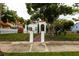 House exterior with a white stucco exterior, wrought iron fence, and a lush lawn at 5501 Bates St, Seminole, FL 33772