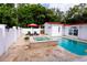 Expansive pool and spa area with a stone patio and lush landscaping at 5501 Bates St, Seminole, FL 33772