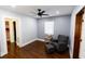 Bright bedroom with hardwood floors, a ceiling fan, and a comfy armchair at 5501 Bates St, Seminole, FL 33772
