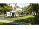 Two-story house with a white stucco exterior, red brick walkway, and a lush lawn at 5501 Bates St, Seminole, FL 33772