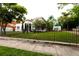 Street view of a charming house with a white stucco exterior and a wrought iron fence at 5501 Bates St, Seminole, FL 33772