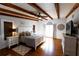 Large main bedroom with hardwood floors, exposed beams, and a king-size bed at 5501 Bates St, Seminole, FL 33772
