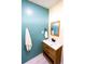 Modern bathroom with teal shiplap, wood vanity, and mirror at 5501 Bates St, Seminole, FL 33772