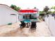 Relaxing pool area with lounge chairs and a red umbrella at 5501 Bates St, Seminole, FL 33772