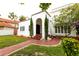 Front entrance with a red brick walkway, arched entryway, and landscaping at 5501 Bates St, Seminole, FL 33772