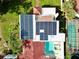 Aerial view showing home with solar panels, pool, and lush landscaping at 5501 Bates St, Seminole, FL 33772