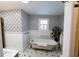 Relaxing bathroom with clawfoot tub and patterned wallpaper at 5501 Bates St, Seminole, FL 33772
