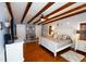 Main bedroom with hardwood floors, exposed beams, and a king-size bed at 5501 Bates St, Seminole, FL 33772