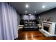Home theater with plush seating, a fireplace, and blackout curtains at 5501 Bates St, Seminole, FL 33772