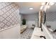 Stunning bathroom with clawfoot tub, double vanity, and patterned wallpaper at 5501 Bates St, Seminole, FL 33772