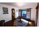 Sunlit dining room with hardwood floors and barn-style doors leading to a sunroom at 5501 Bates St, Seminole, FL 33772