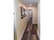 Long hallway with wood-look flooring, coat hooks, and access to other rooms at 5501 Bates St, Seminole, FL 33772