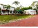 Backyard view showing the detached garage and a brick paved driveway at 5501 Bates St, Seminole, FL 33772