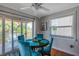 Dining area with round table and four teal chairs next to kitchen at 1809 Gulf Blvd, Indian Rocks Beach, FL 33785