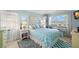 Cozy bedroom with a queen-sized bed, matching side tables, and a window showcasing beautiful beach views at 11000 Gulf Blvd # 301, Treasure Island, FL 33706