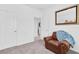 Spare bedroom featuring neutral decor and a leather chair creating a peaceful and functional retreat at 879 De Soto Way, Tarpon Springs, FL 34689