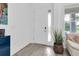 Bright entryway with neutral walls, wood-look tile flooring, and a glass-paneled front door at 879 De Soto Way, Tarpon Springs, FL 34689