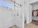 Modern bathroom with a tiled shower and glass enclosure, next to the closet at 879 De Soto Way, Tarpon Springs, FL 34689