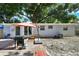 Back of house, gray siding, sliding glass doors, and patio at 8996 Southern Comfort, Largo, FL 33773