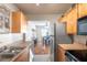Modern kitchen with stainless steel appliances and light wood cabinets at 5157 Beach Se Dr # C, St Petersburg, FL 33705