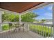 Covered balcony with water view and small table at 5157 Beach Se Dr # C, St Petersburg, FL 33705