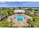 Community pool with surrounding lounge chairs and clubhouse at 5157 Beach Se Dr # C, St Petersburg, FL 33705