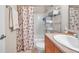 Clean bathroom with tub shower, vanity, and shelving at 5157 Beach Se Dr # C, St Petersburg, FL 33705