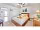 Bedroom with a wooden bed frame, access to a patio, and tropical decor at 5157 Beach Se Dr # C, St Petersburg, FL 33705