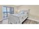 Bedroom with white wooden bed and ocean view at 403 Gulf Way # 302, St Pete Beach, FL 33706