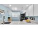 Modern kitchen with white cabinets and stainless steel appliances at 403 Gulf Way # 302, St Pete Beach, FL 33706