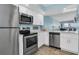 Modern kitchen with stainless steel appliances and white cabinets at 403 Gulf Way # 302, St Pete Beach, FL 33706
