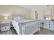 Bedroom with white wooden bed and dresser at 403 Gulf Way # 302, St Pete Beach, FL 33706
