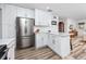 Modern kitchen featuring white shaker cabinets, stainless steel appliances, and a marble countertop at 1049 Marine St, Clearwater, FL 33755