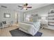 Bright bedroom with a cozy bed, built-in shelves, and ceiling fan at 1200 Eden Isle Ne Blvd, St Petersburg, FL 33704