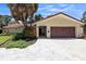 Front view of house with driveway and landscaping at 1200 Eden Isle Ne Blvd, St Petersburg, FL 33704