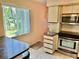 Kitchen area with stove, microwave and cabinets at 2042 Australia W Way # 28, Clearwater, FL 33763