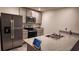 Modern kitchen with stainless steel appliances and granite countertops at 16717 Parker River St, Wimauma, FL 33598