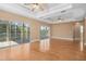 Large living room with hardwood floors, high ceilings, and access to a balcony at 7545 Gulf Way, Hudson, FL 34667