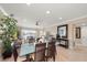 Bright dining room with glass-top table and seating for six at 400 Larboard Way # 106, Clearwater Beach, FL 33767