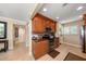 Well-equipped kitchen with wood cabinets and granite counters at 400 Larboard Way # 106, Clearwater Beach, FL 33767